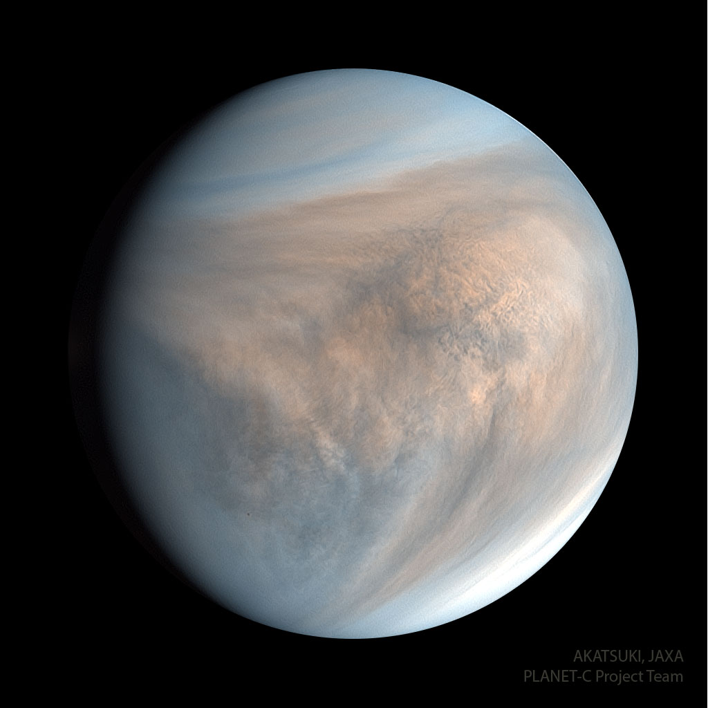 Na zdjęciu pokazano planetę Wenus w nadfiolecie. Sferyczna
planeta ma kolisty kształt i zabarwiona jest na brązowo
z dodatkiem błękitu. Wyraźnie widoczne są złożone wzory chmur. 
Zobacz opis. Po kliknięciu obrazka załaduje się wersja o największej dostępnej rozdzielczości.