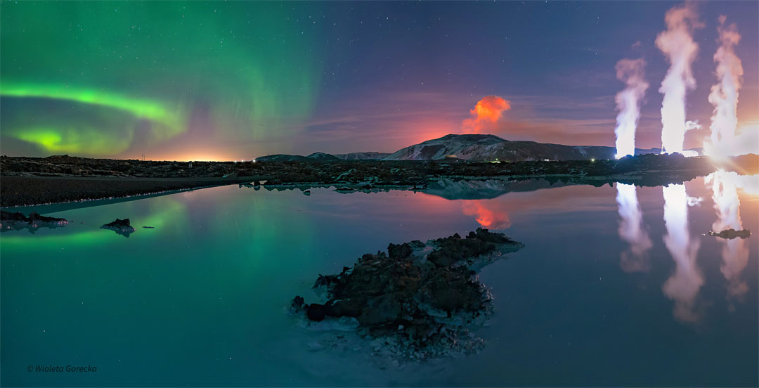 A body of water is seen in front of a night sky. The
water reflects the sky. In the sky, on the right are green
aurora. In the center is an orange plume. On the right
are three while plumes. 
Więcej szczegółowych informacji w opisie poniżej.
