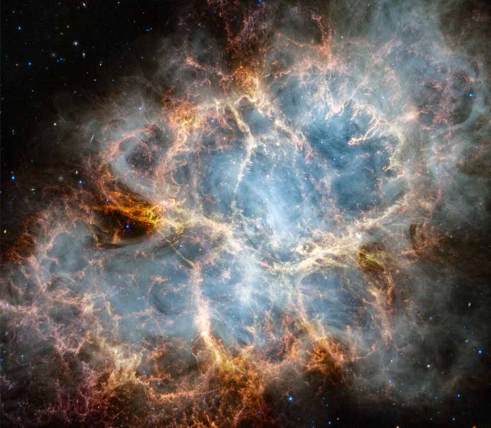 Na zdjęciu pokazana jest Mgławica Krab, sfotografowana przez
Teleskop Kosmiczny Jamesa Webba (JWST). Nałożone zdjęcie natomiast
jest zdjęciem tej samej Mgławicy Krab, tym razem jednak wykonanym
przez Teleskop Kosmiczny Hubble'a (HST). Zdjęcie z Webba wykonano
w bliskiej podczerwieni, zdjęcie z Hubble'a zaś -- w świetle widzialnym.
Zobacz opis. Po kliknięciu obrazka załaduje się wersja
o największej dostępnej rozdzielczości.