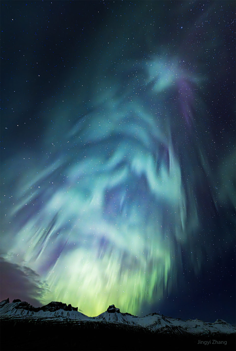 A star filled night sky is shown with aurora
visible in blue, purple and green. The aurora could
be perceived to be a spruce tree, or even a 
Christmas tree. 
Więcej szczegółowych informacji w opisie poniżej.