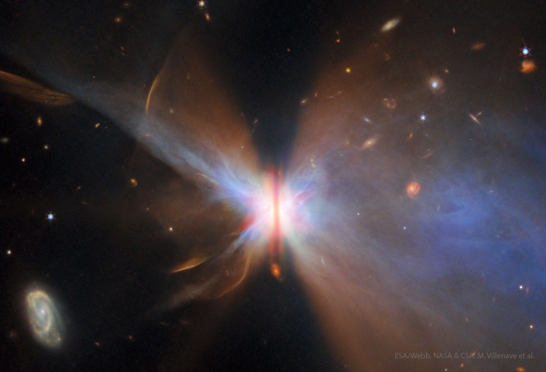 A starfield surrounds a nebula with a vertical brown bar
across its center. Gas and dust fan out from the bar
making the nebula appear like a colorful butterfly. 
Więcej szczegółowych informacji w opisie poniżej.