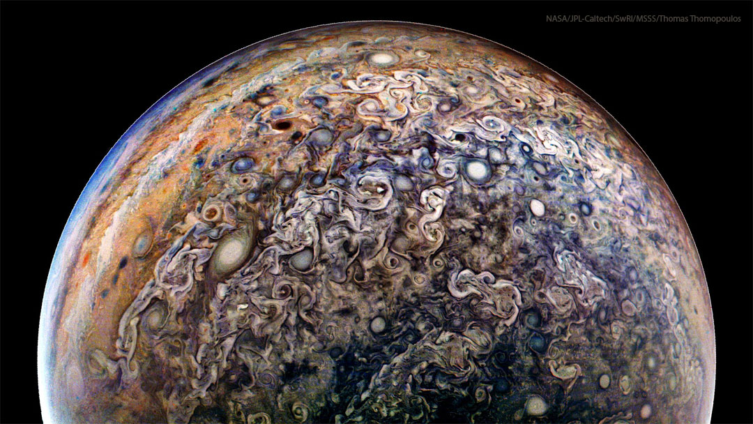 The planet Jupiter is shown from an unusual angle. Most
prominent are a miasma of jumbled and swirling clouds including
many oval storms. 
Więcej szczegółowych informacji w opisie poniżej.