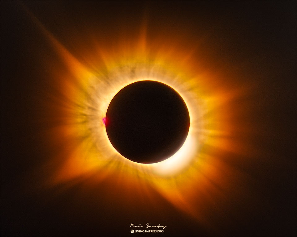 A total eclipse Sun is featured in the image center.
Around the Sun is a filamentary gold-hued corona flowing
out in all directions. 
Więcej szczegółowych informacji w opisie poniżej.